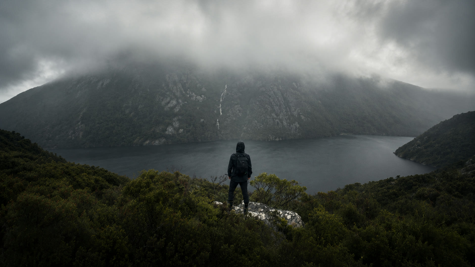 Lucas overlooking a misty mountain lake